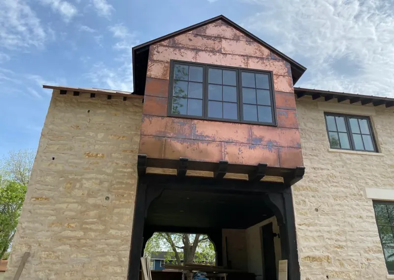 Copper metal panel facade on a stone building for Skylight Installation in Forestdale